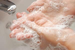 woman washing hand under running